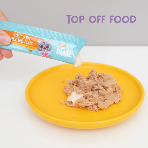 A photo of a yellow bowl with pate wet food and a tube of mousse being squeezed on top of the food. With text that says "top off food"