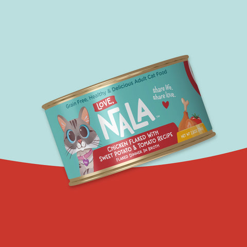 A tilted can of NALA Love Adult Cat Food on a stylized light blue and red background. The can features a teal label with a cartoon cat, the brand name 'NALA' in large white letters, and text for 'Chicken Flaked with Sweet Potato & Tomato Recipe'.