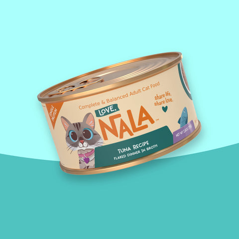 A single can of Nala Love brand adult cat food, tuna recipe, shown at an angle on a stylized light blue and teal background.