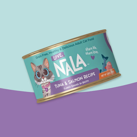 A single can of NALA brand adult cat food, specifically Tuna & Salmon Recipe, shown at an angle against a split pastel blue and purple background.
